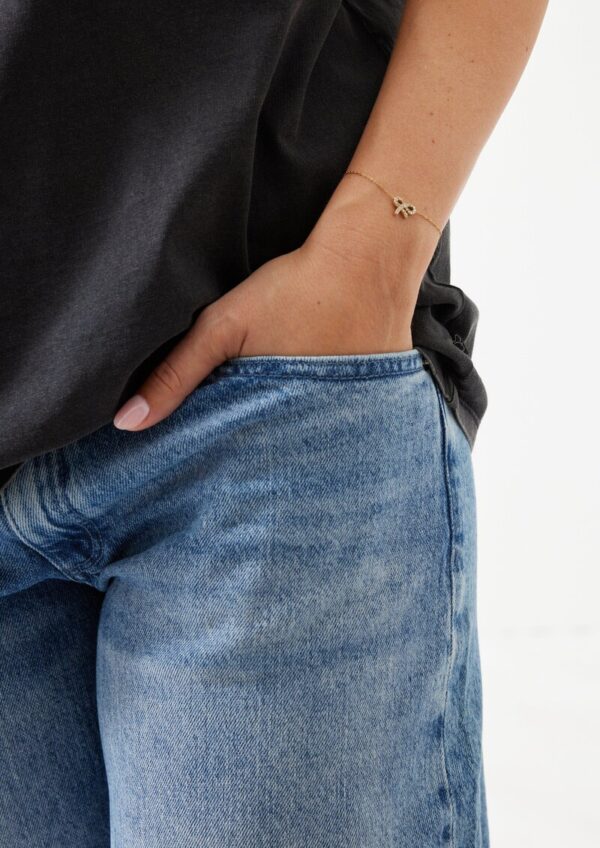 Edelstahlarmband mit goldener IP Beschichtung und Schleifen-Detail